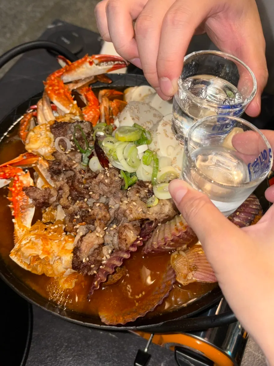 Picked-out crab meat alongside a shot of soju