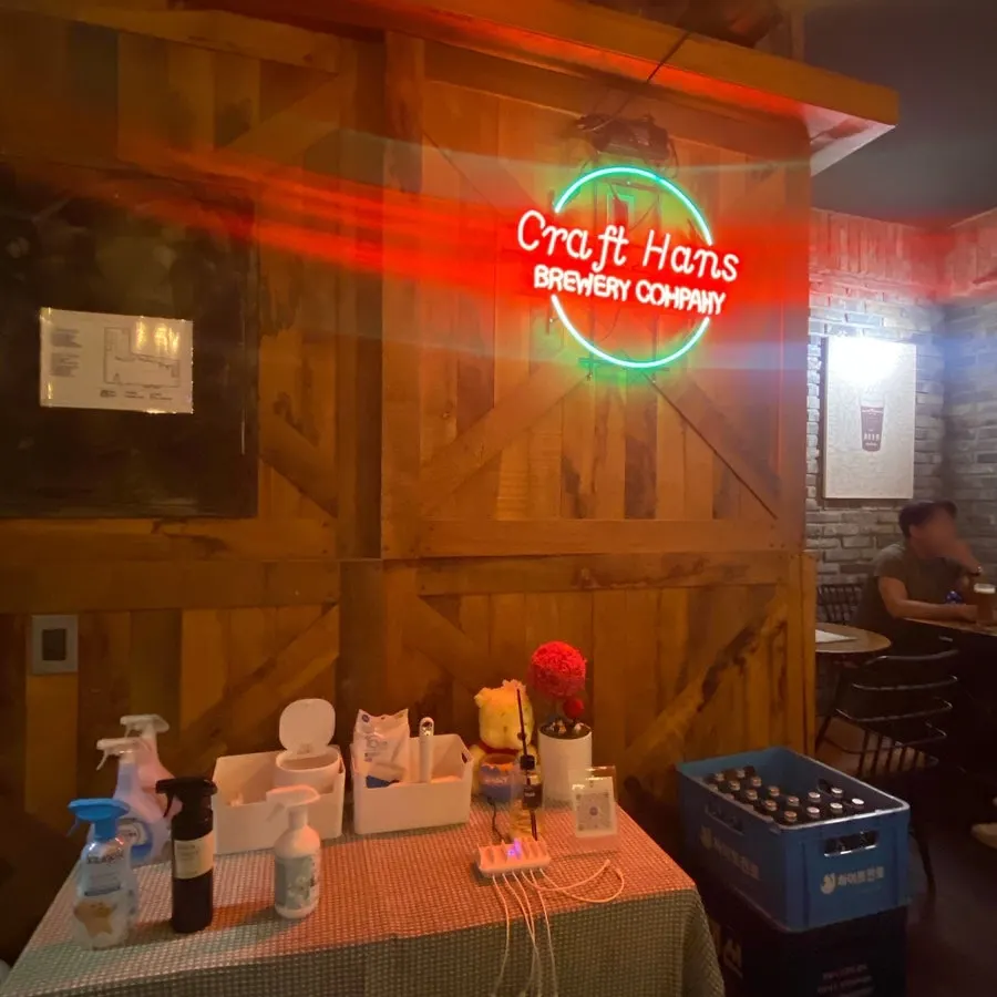 Pub seating with wood walls and neon signs