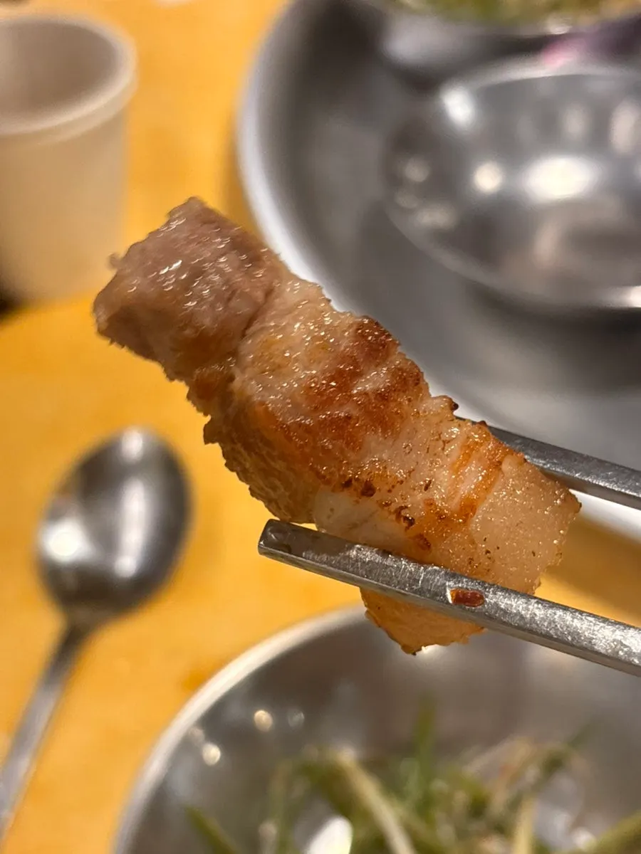 A piece of pork neck dipped in salt