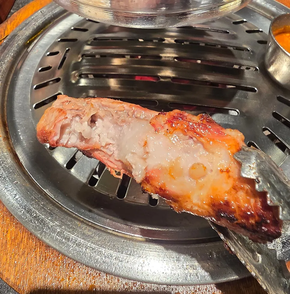 A pork rib ssam with assorted ingredients
