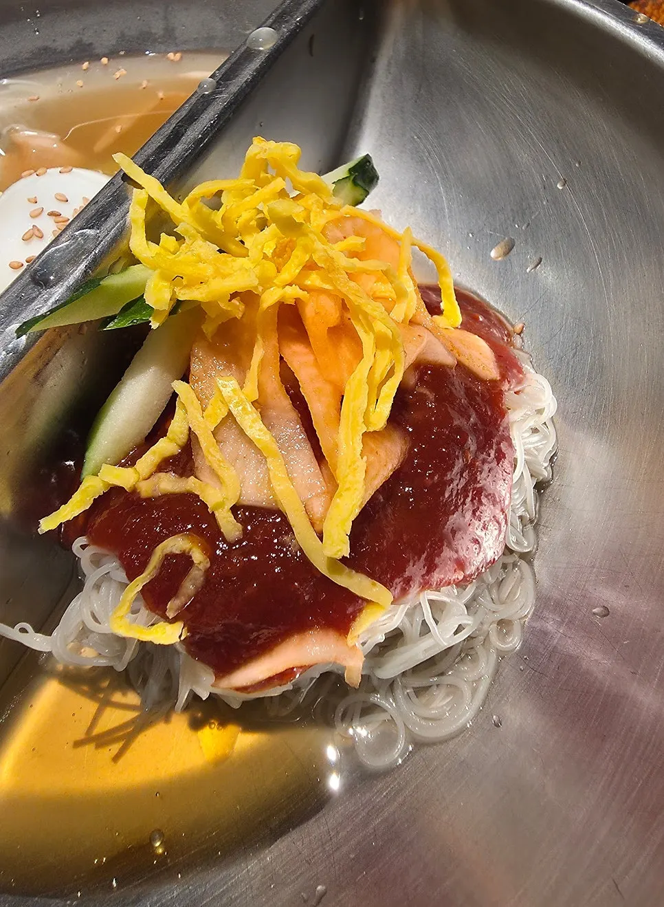 Half-and-half naengmyeon with mul-naengmyeon and bibim-naengmyeon