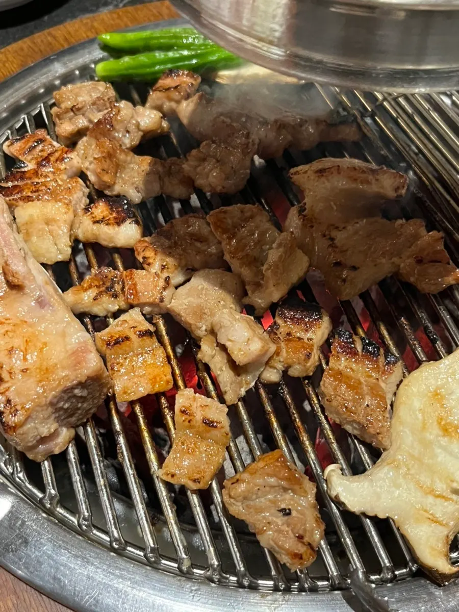 Grilling the added half portion of marinated pork ribs