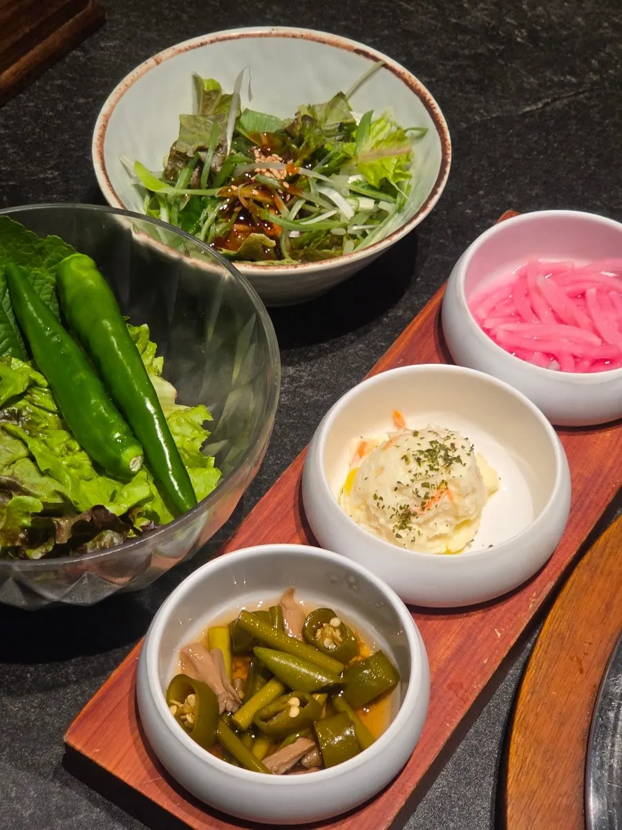 Side dish spread with barley white kimchi and potato salad
