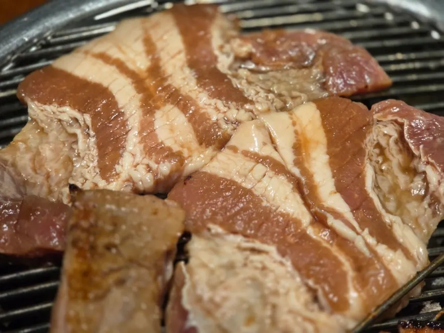 Table set with finished marinated ribs and side dishes