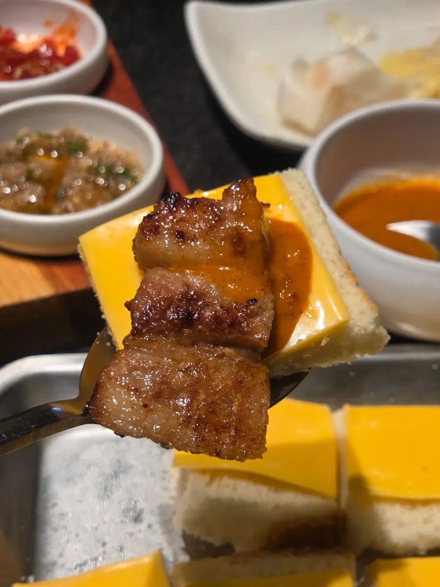 Toasted bread served with cheddar cheese and mala sauce