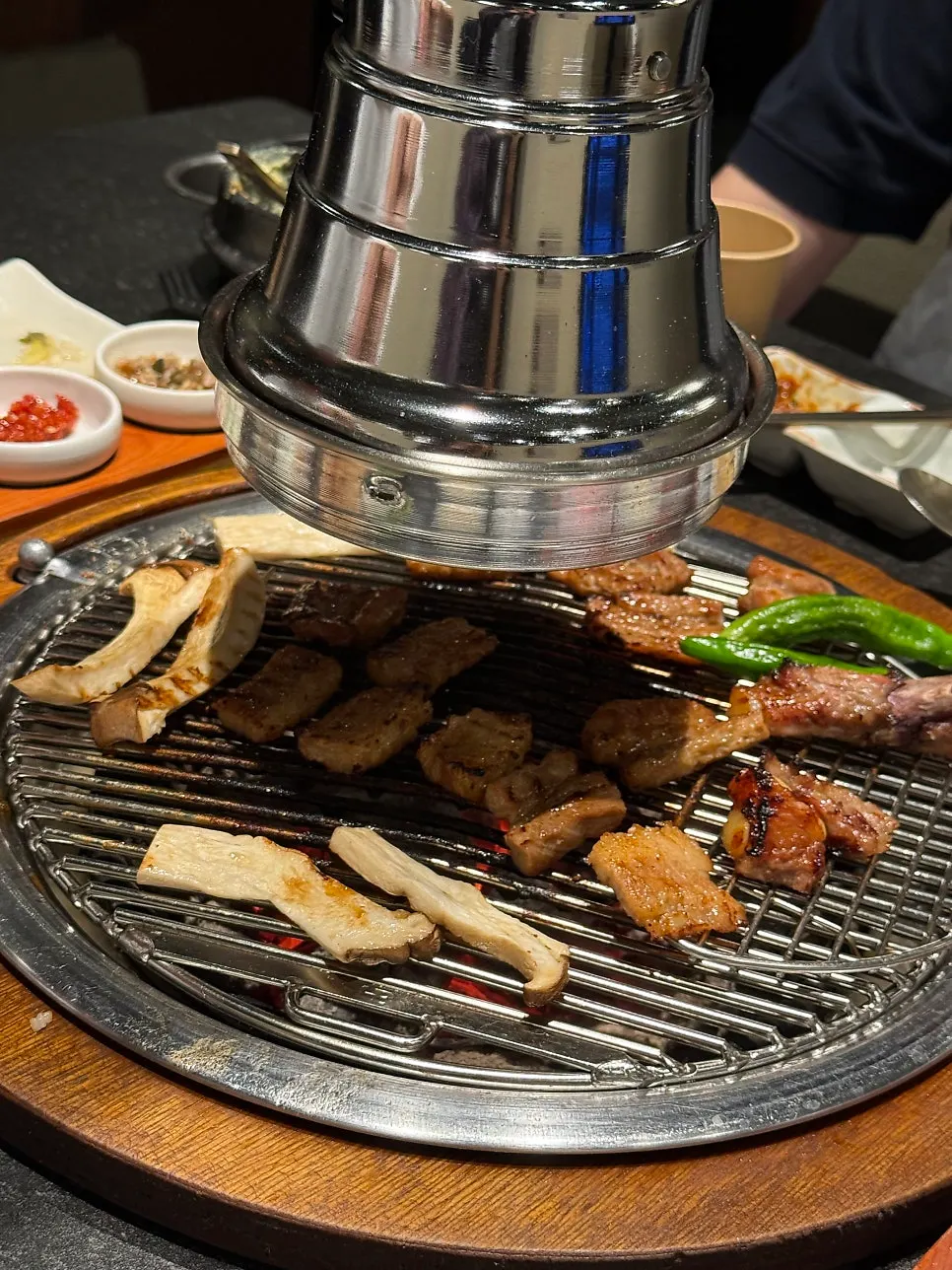 Golden-brown marinated ribs grilling over charcoal