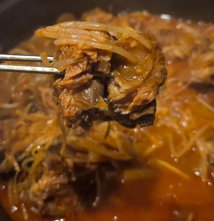 A piece of braised ribs placed over rice