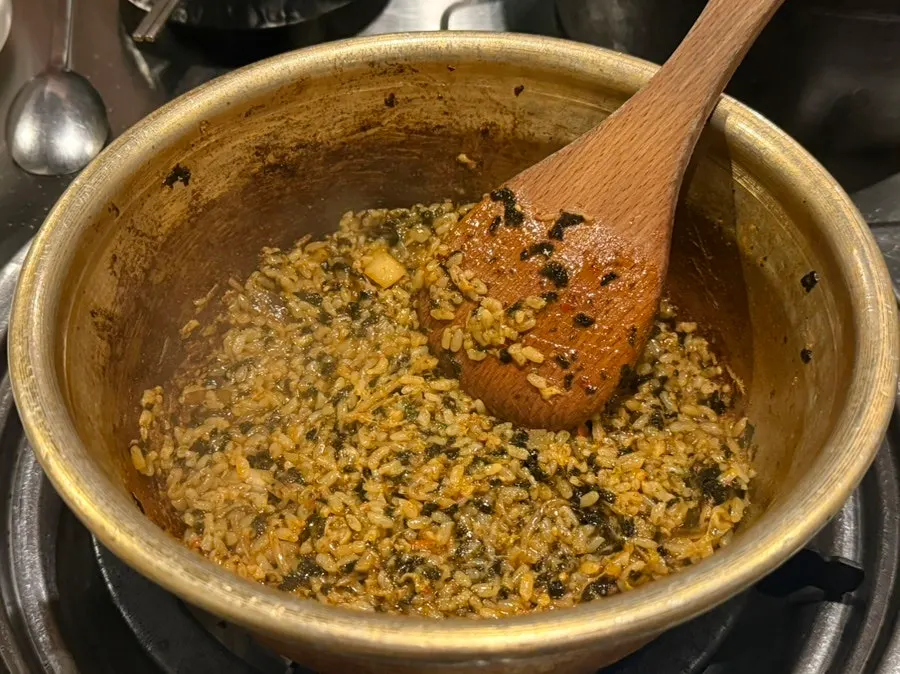 Staff stir-frying rice in the leftover sauce