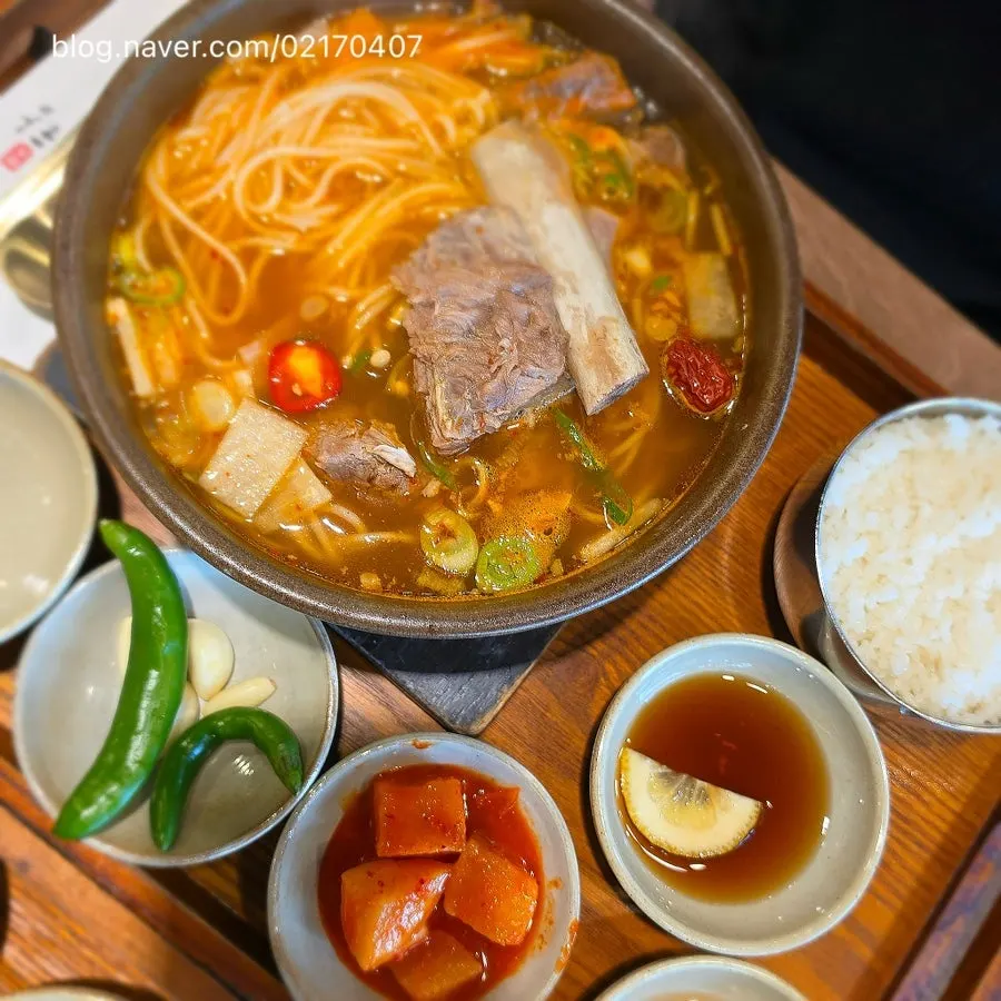 Rice mixed into the broth with meat and glass noodles on top