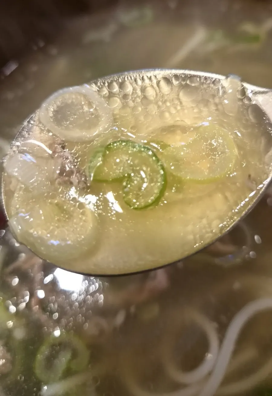 A spoonful of rich galbitang broth