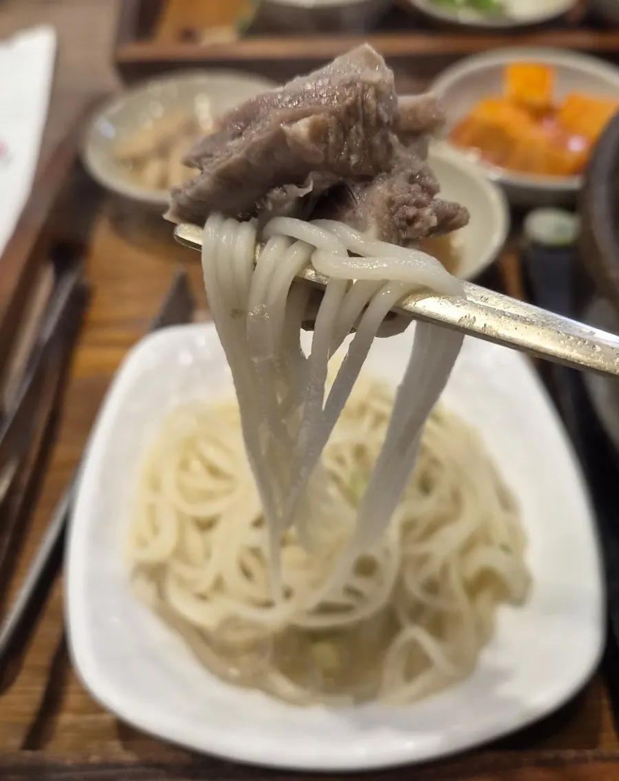 Close-up of galbitang with added Jeju jungmyeon noodles