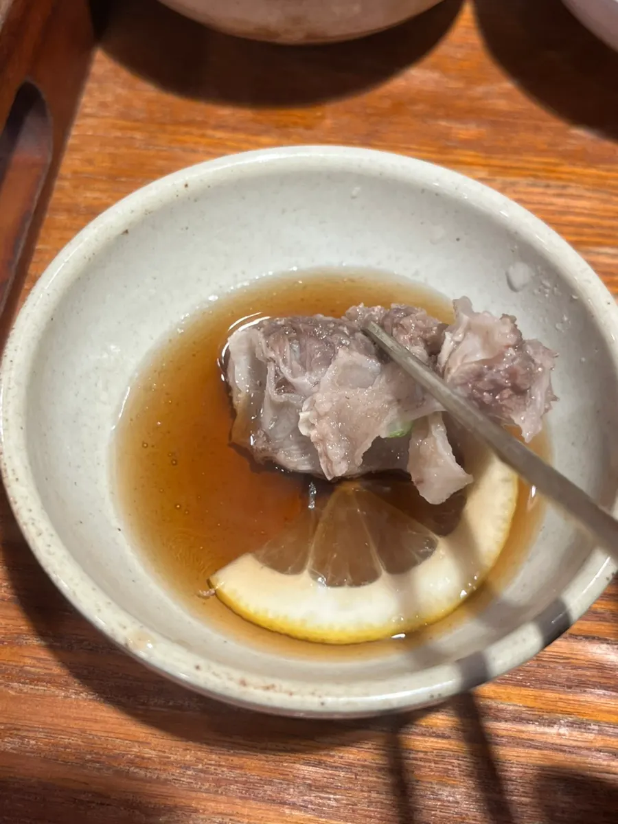 Lemon soy sauce topped with a lemon slice