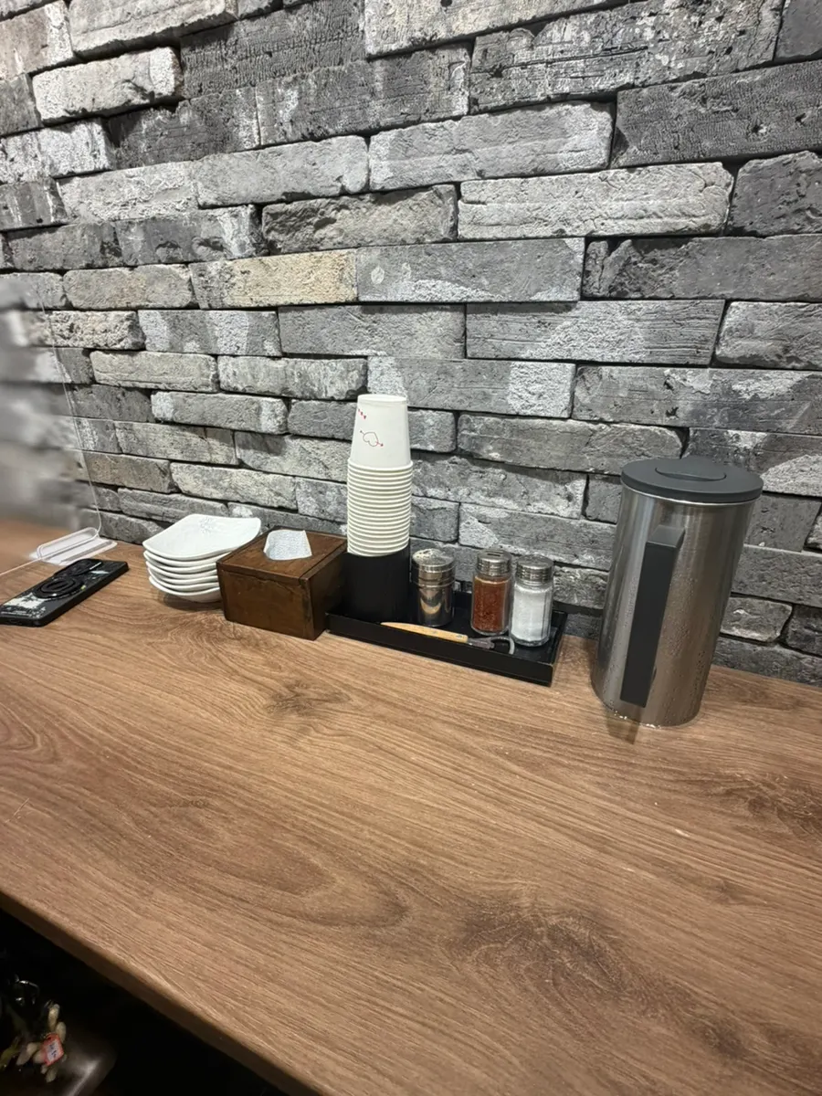Salt and chili powder containers on the table