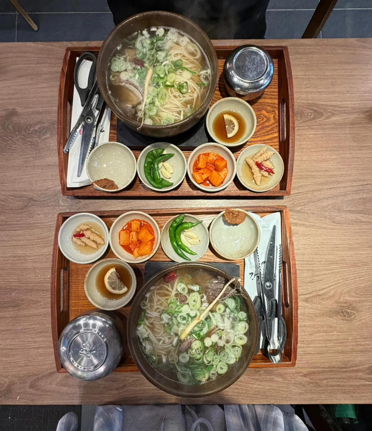 A full spread of galbitang and side dishes