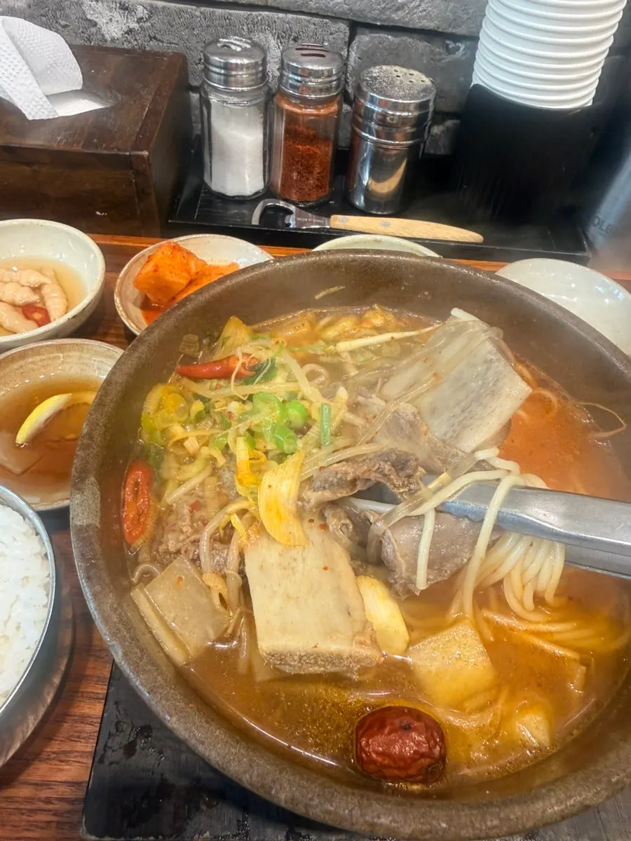 A chopstick-full of noodles pulled from the broth