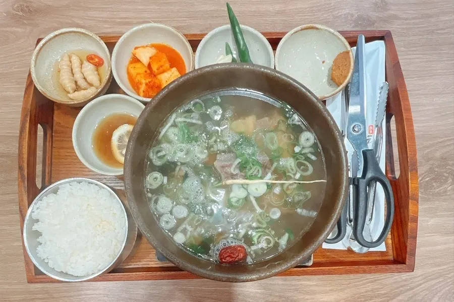 Large galbitang bowl with rice and side dishes