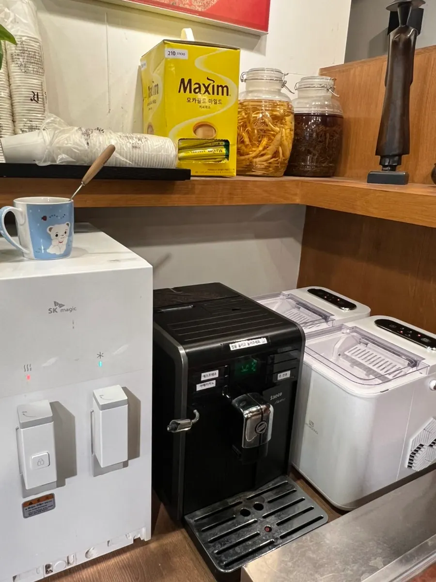 Self-service corner with Maxim coffee and brewed americano