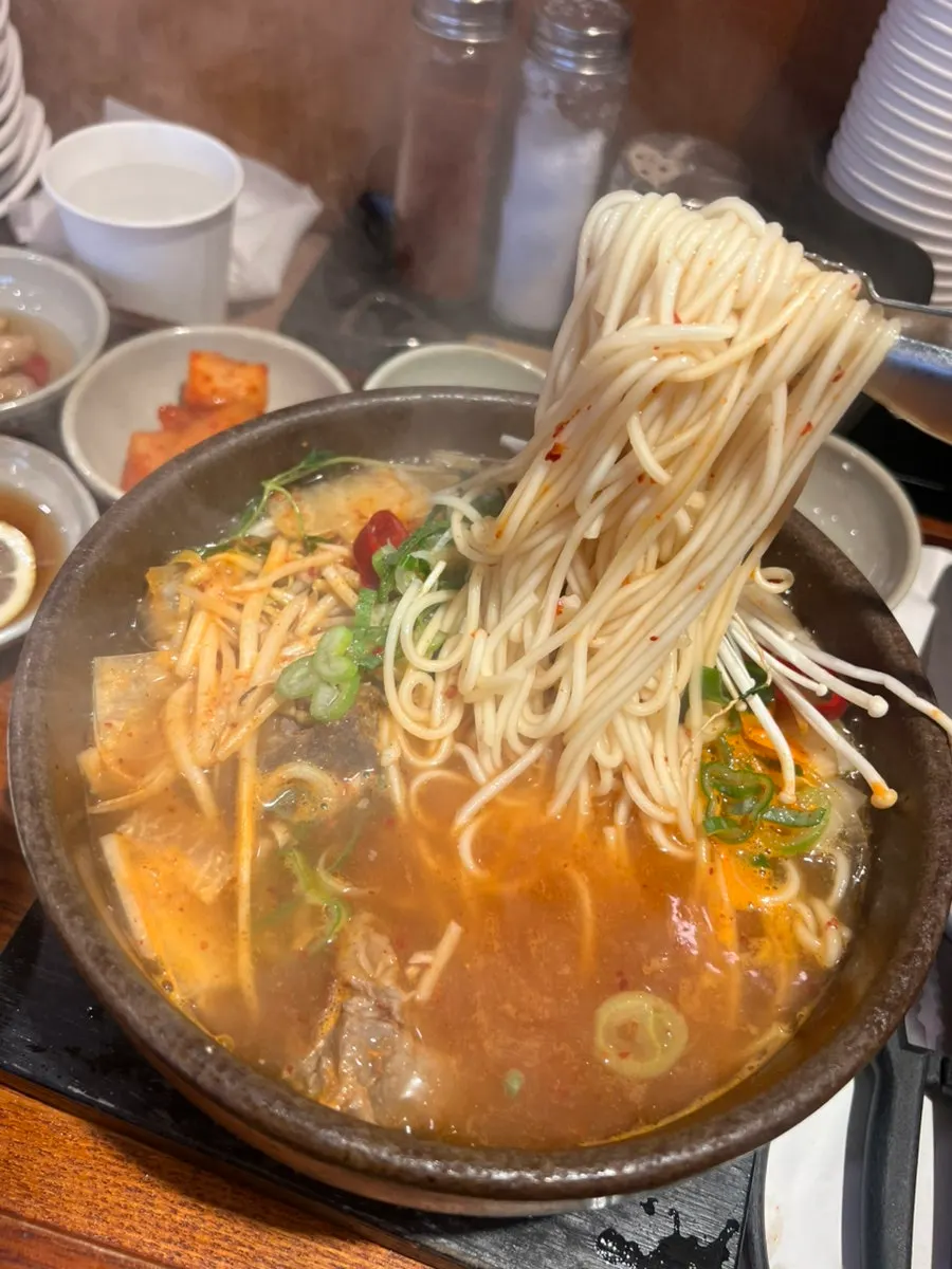 Jeju medium noodles served in the spicy broth