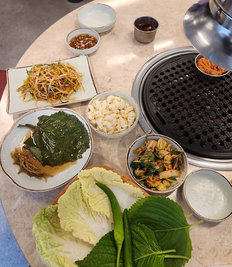 Menu board listing gamjagisal and gochujang pork belly