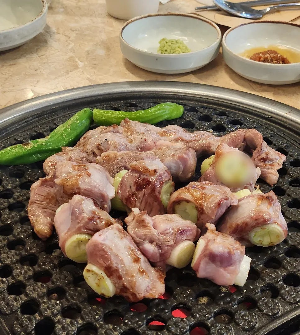 Green onion gamjagisal cooking on the grill