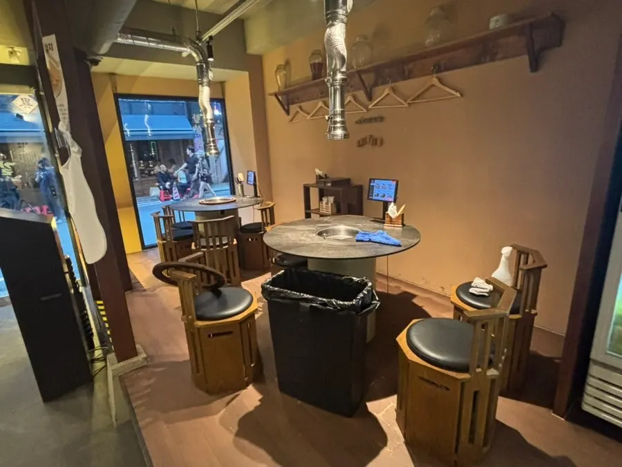 Interior seating divided by booth partitions at Gilchon Sutbul Galbi