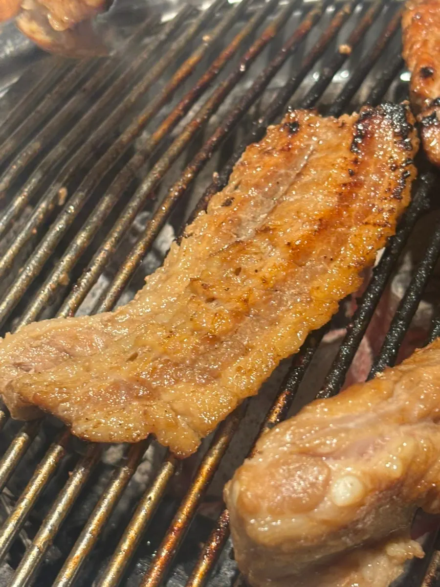 Marinated pork ribs cooking to a golden brown