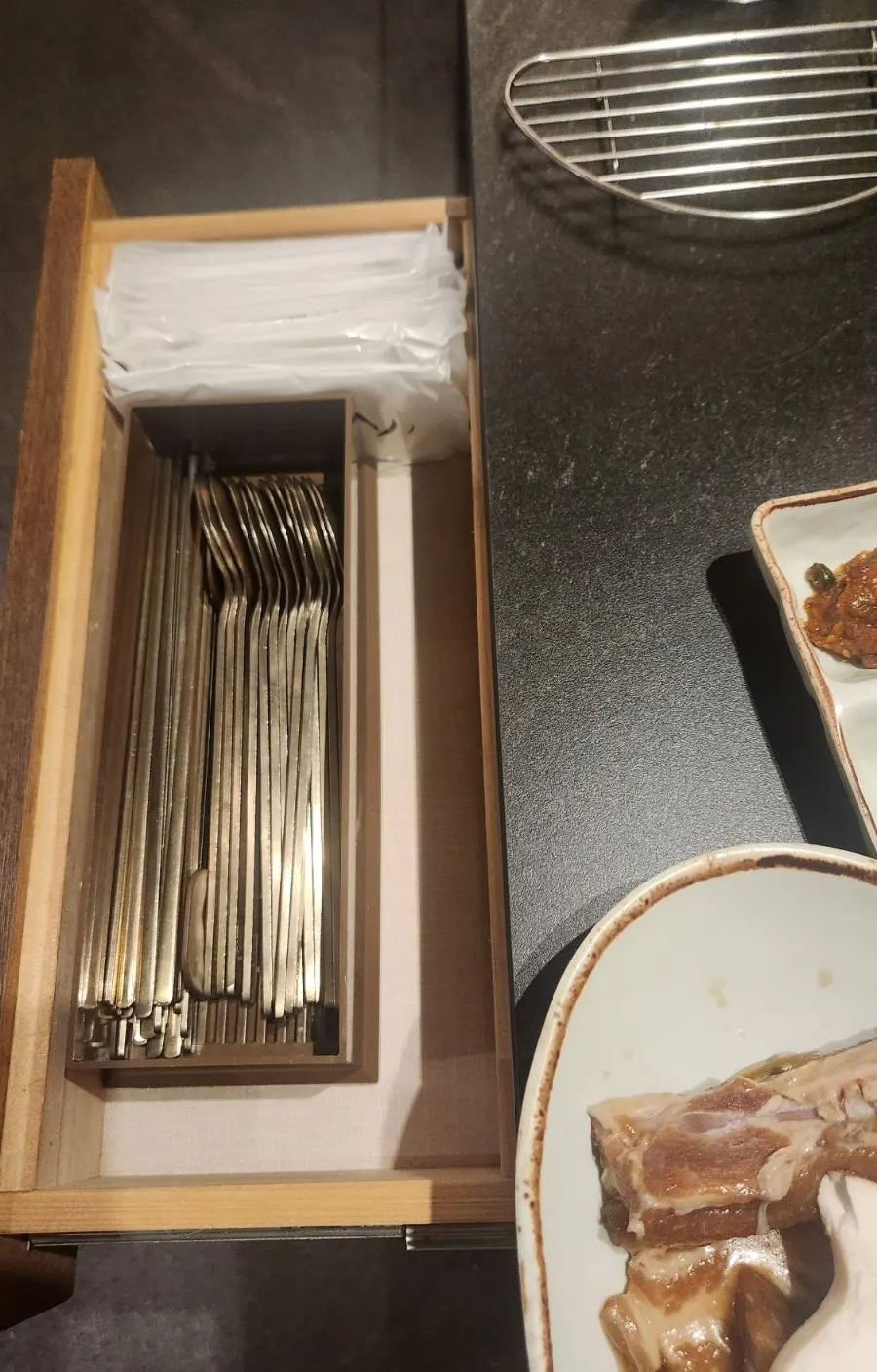 Spoons and wet wipes stored beside the table