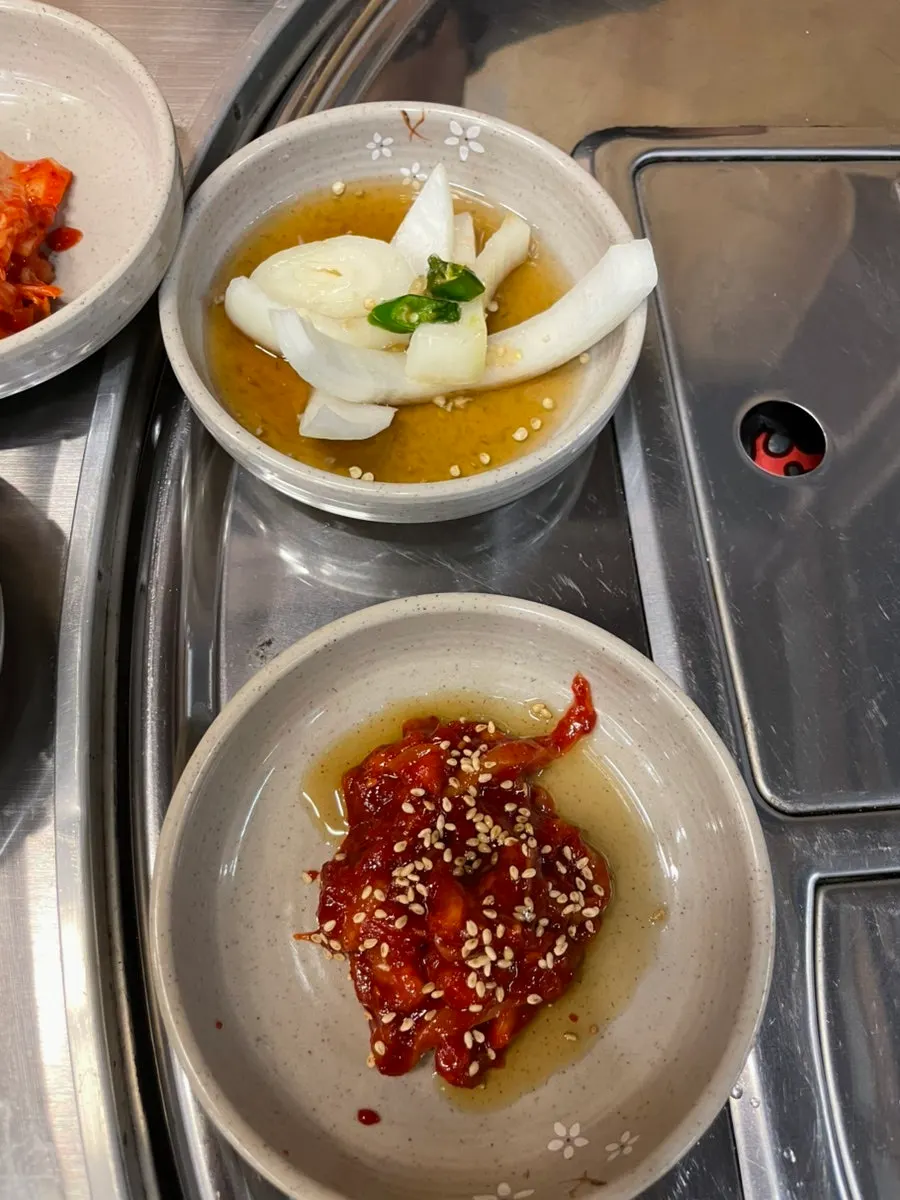 White kimchi and dried radish strips among the side dishes