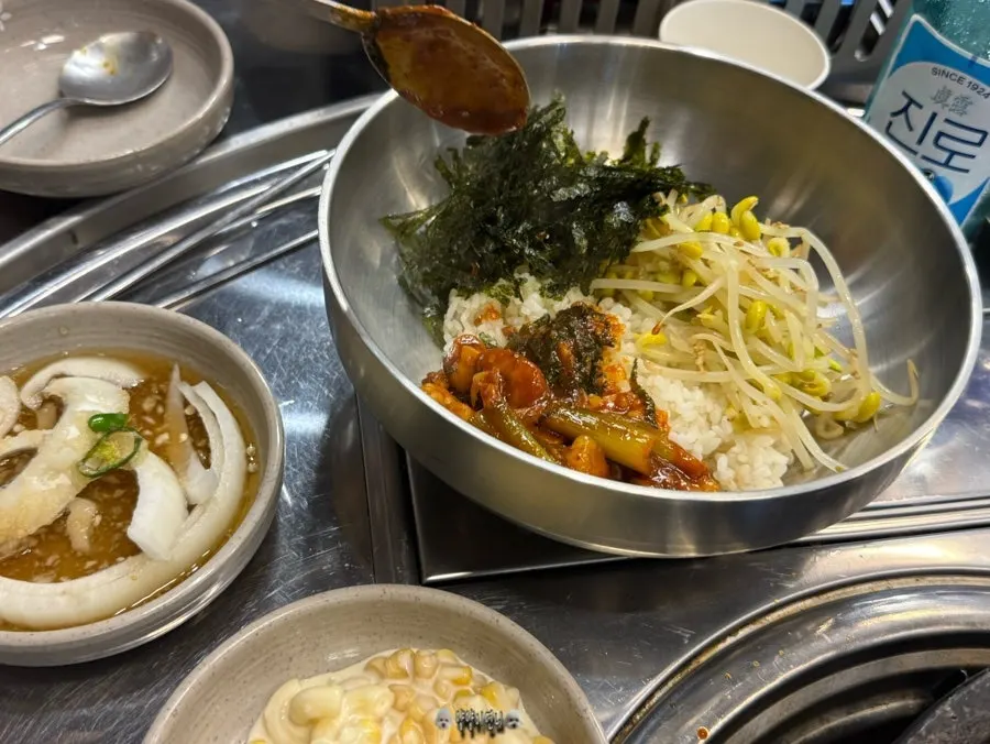 Bowl of rice topped with bean sprouts and seaweed