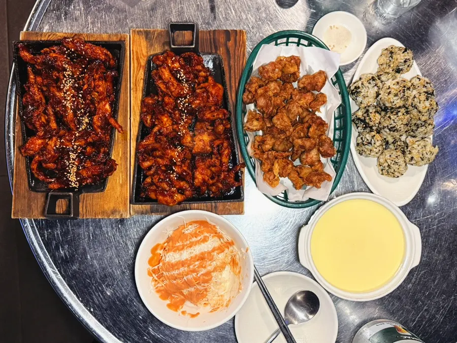 A spread with boneless dakbal and grilled chicken neck served together