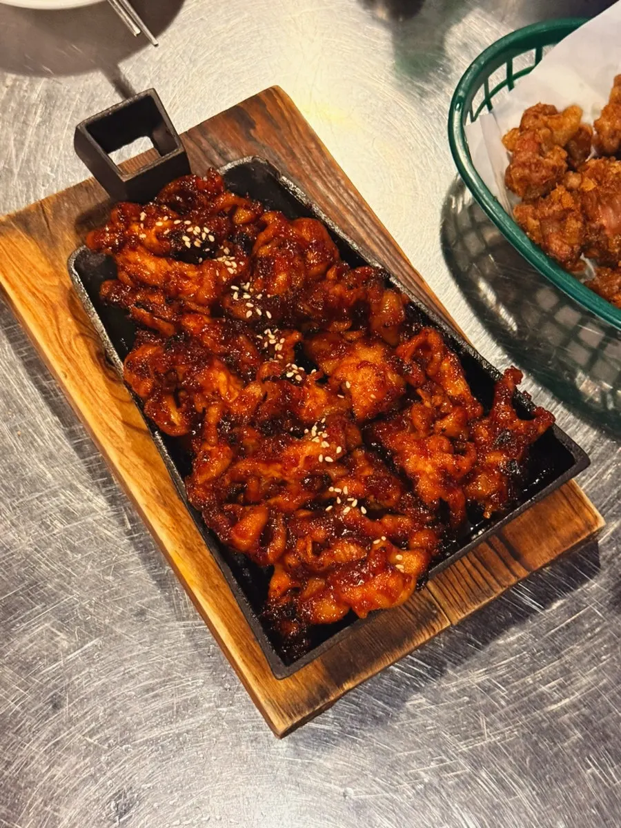 Red-sauced boneless dakbal filling a hot plate