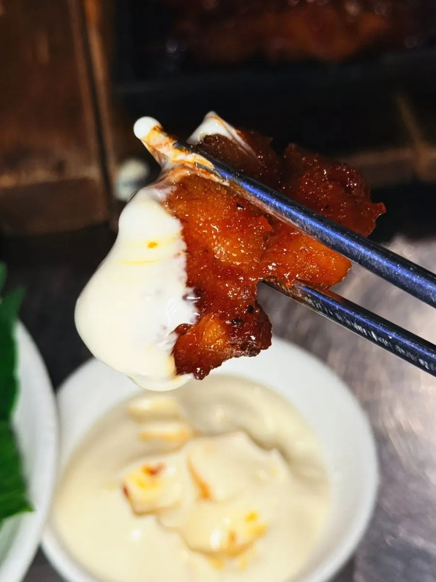 A piece of boneless dakbal placed on a rice ball
