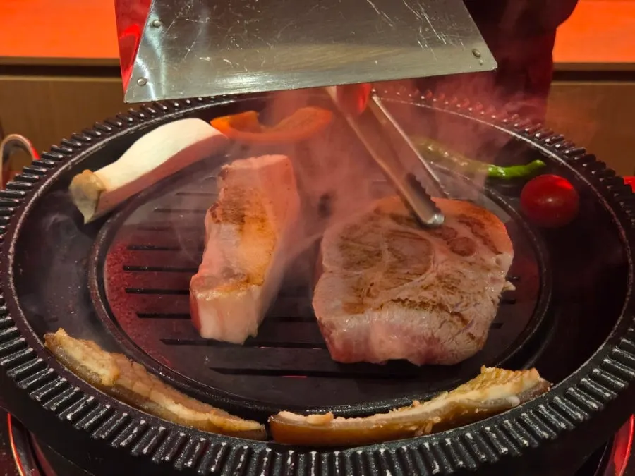Half whole-pig set placed on the grill