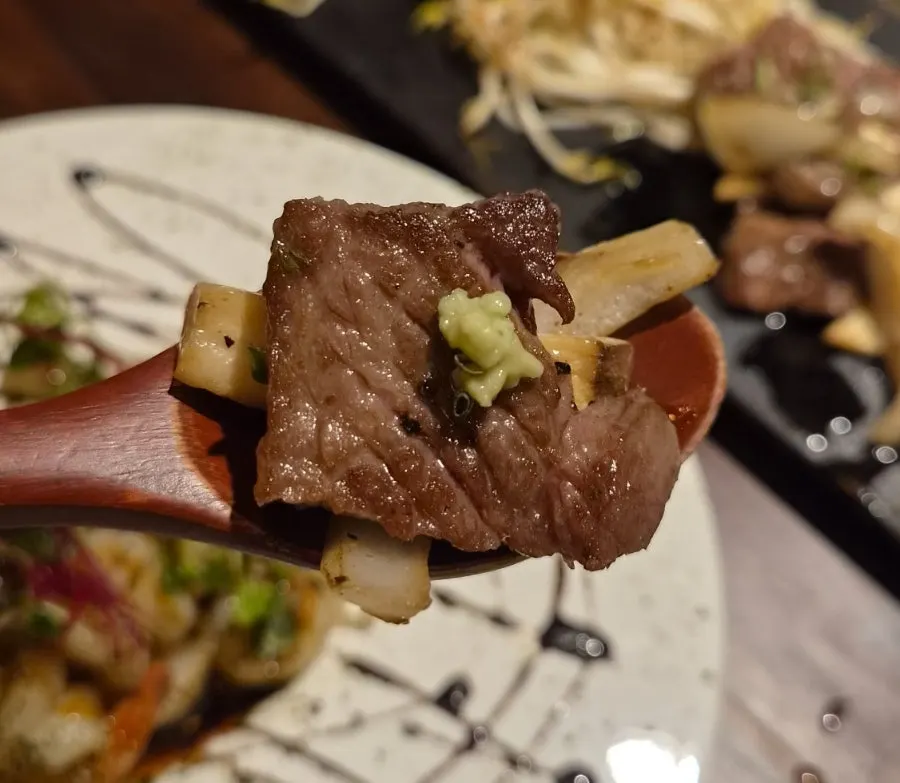 A piece of wagyu kkotgalbisal steak topped with wasabi