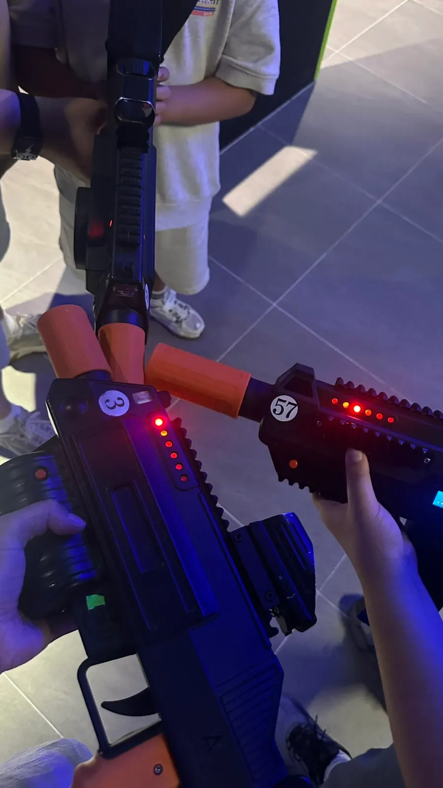 A kid holding a laser gun with a serious expression