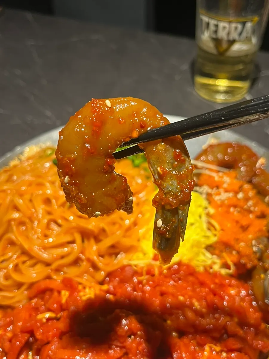 A bite of yukhoe coated in sauce