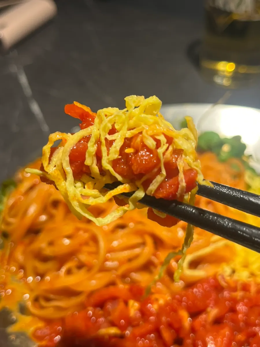 A bite with egg garnish added on top