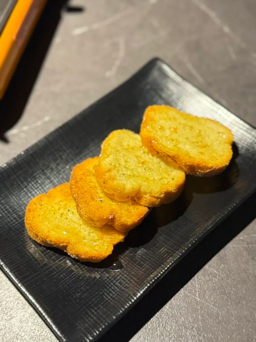 Complimentary garlic bread on the table