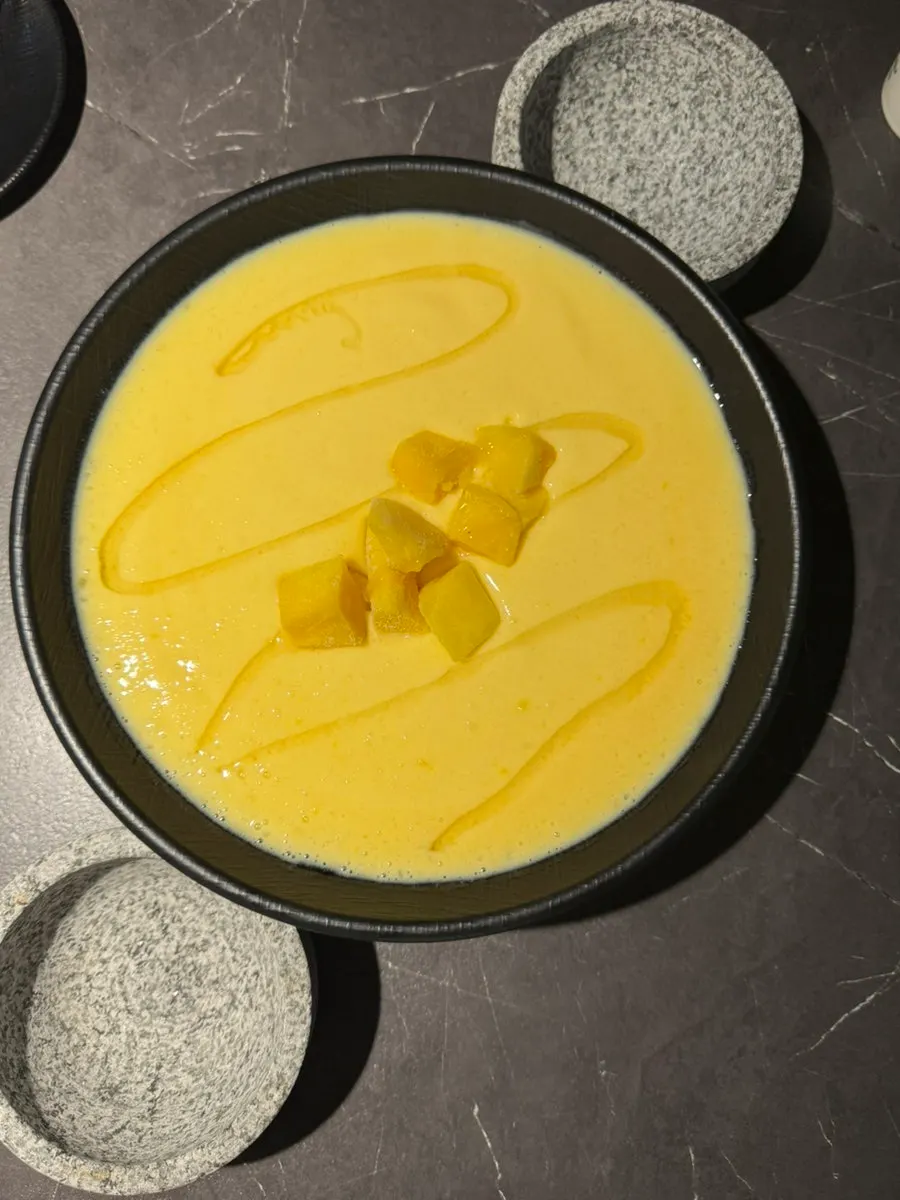 Honey mango craft makgeolli served in a large bowl