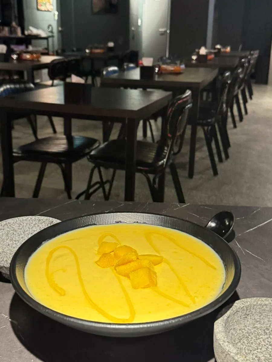 Honey mango makgeolli with the small cup for ladling