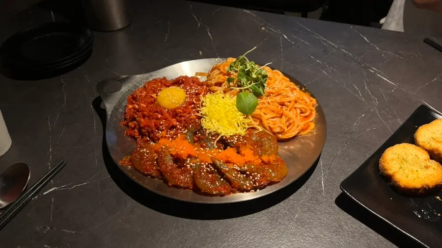 Full spread of yukhoe shrimp jang kalbibim and flying fish roe rice balls