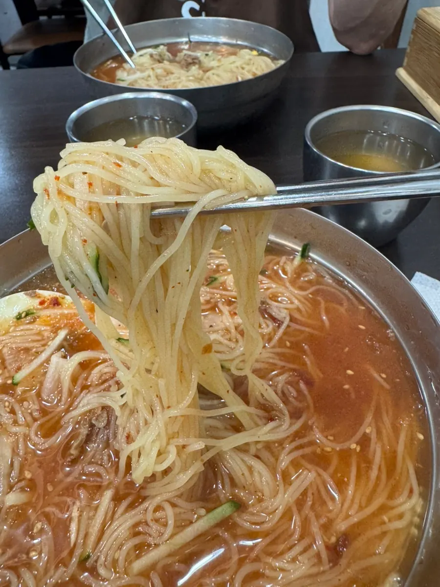 Table with mul-milmyeon and dumplings at Seomyeon Milmyeon