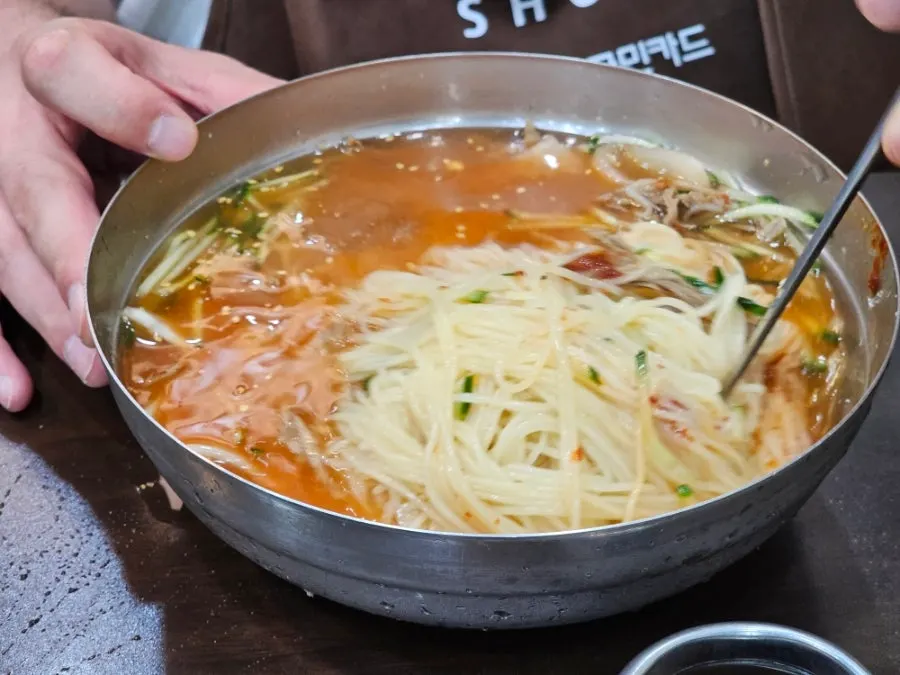 Thin mul-milmyeon noodles lifted with chopsticks
