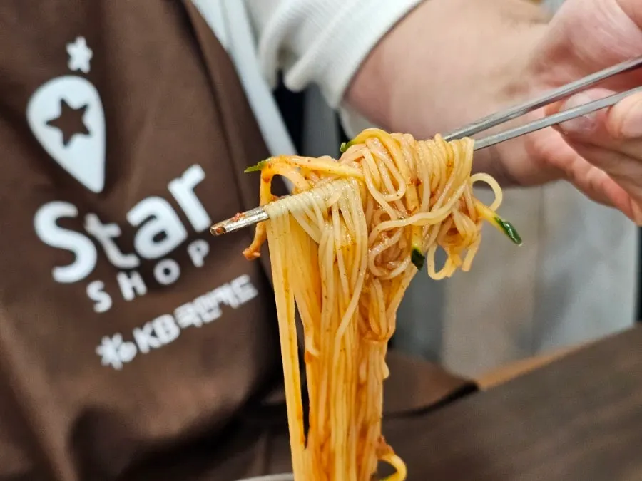 Mixed bibim-milmyeon served alongside dumplings