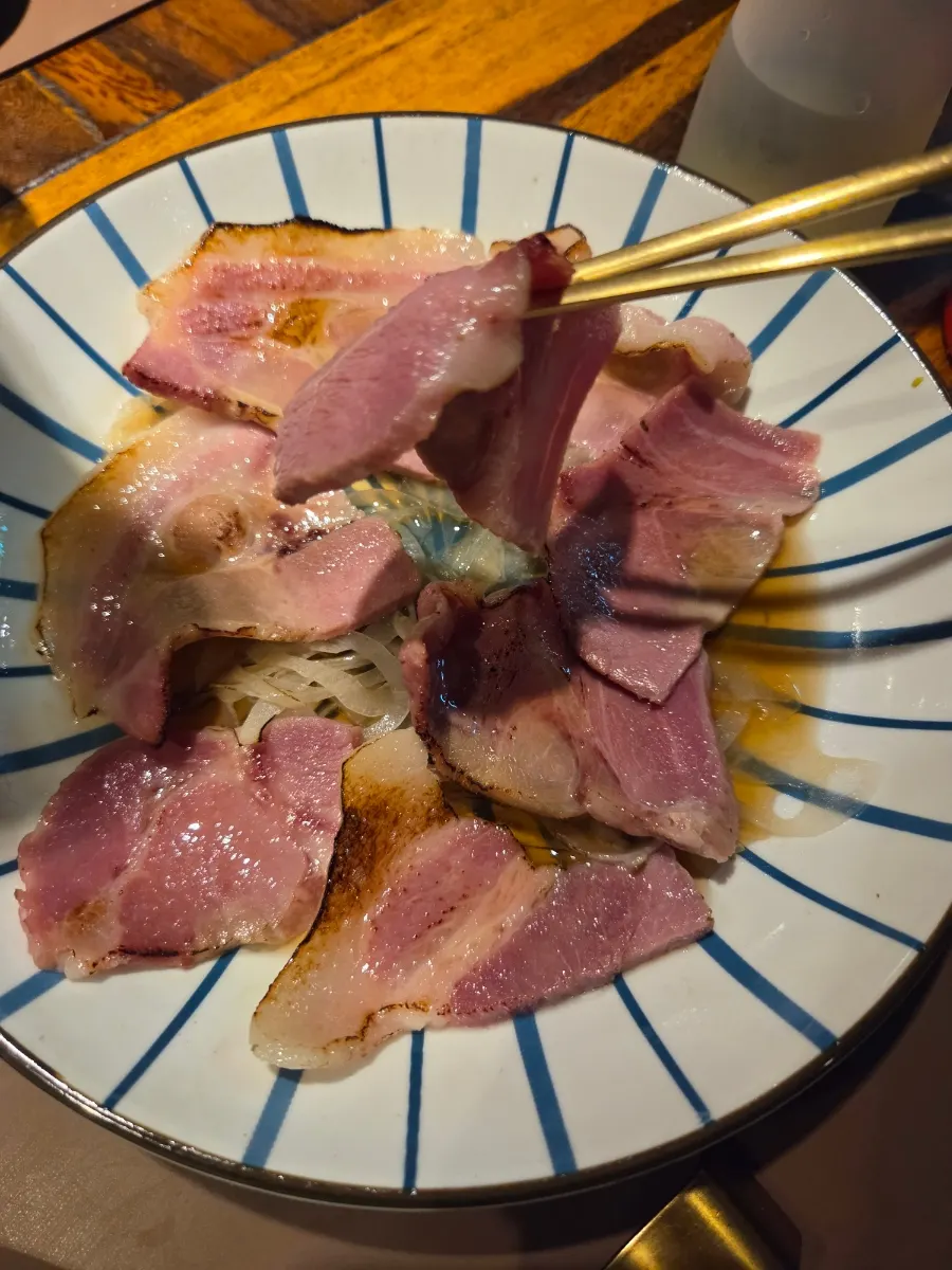 Charcoal-grilled boiled pork served alongside milmyeon and pork soup