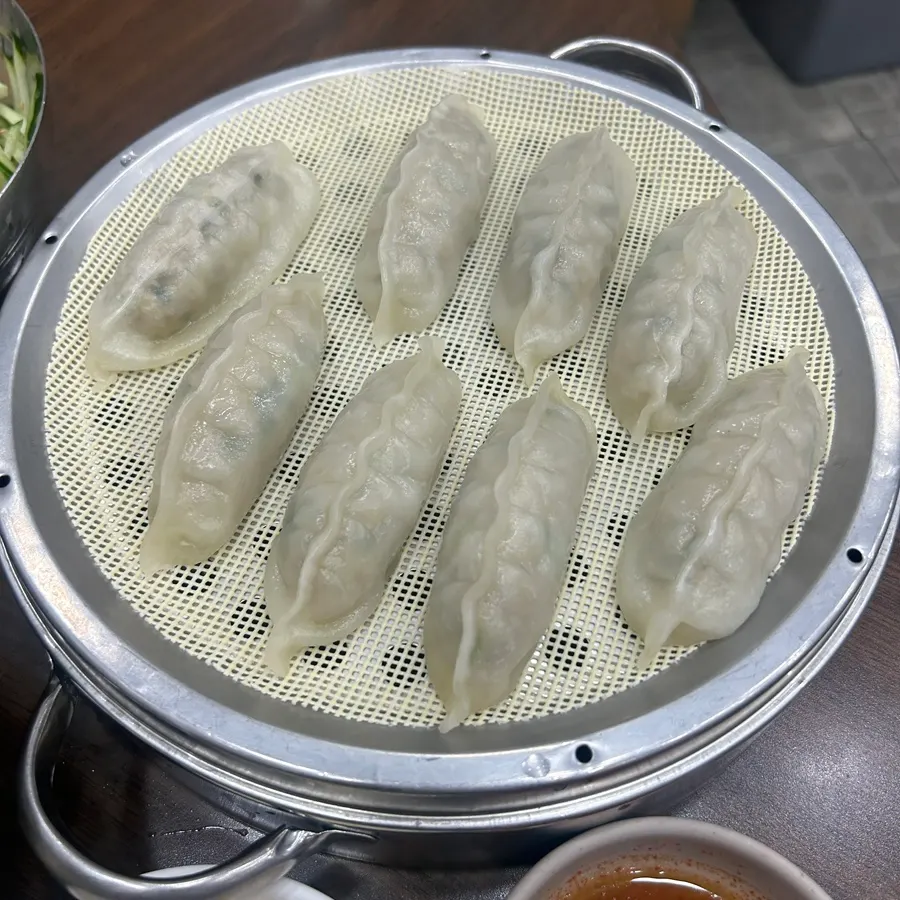 A hot dumpling dipped in soy sauce