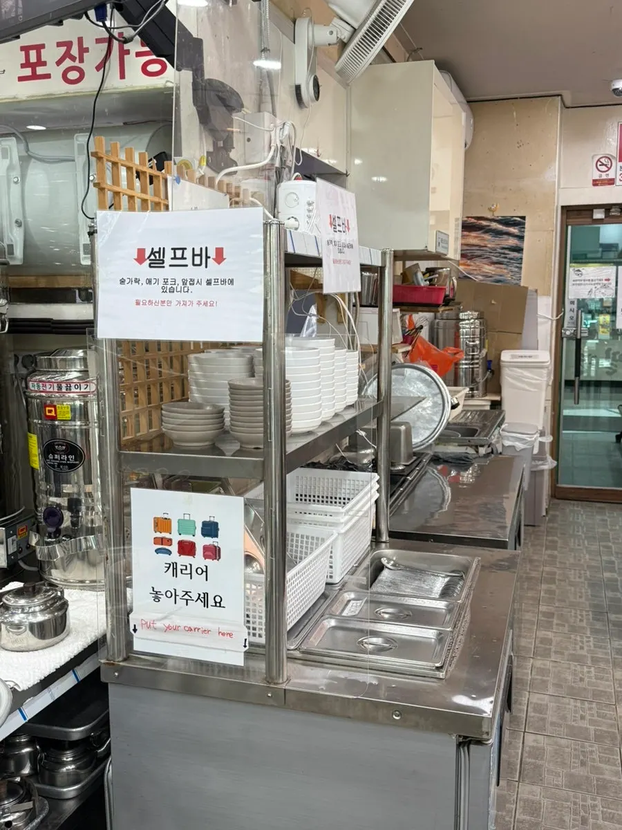 Menu board showing milmyeon and dumplings at Seomyeon Milmyeon