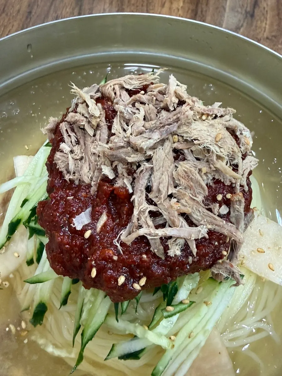 Beef brisket topping visible beneath the egg on the milmyeon