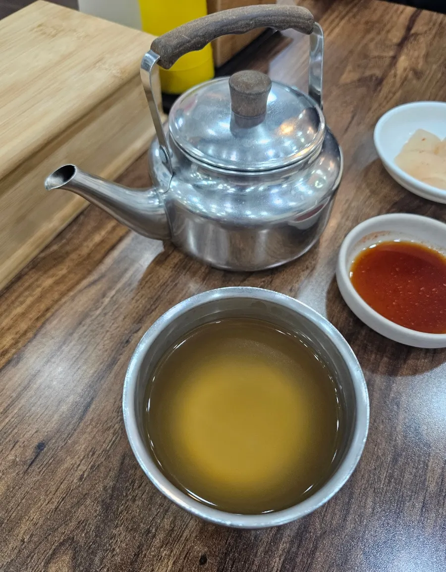Hot broth from Seomyeon Milmyeon poured into a cup