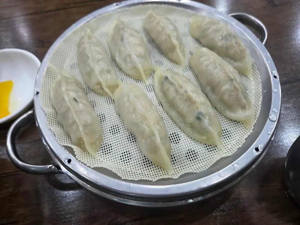 A thin-wrapped dumpling picked up with chopsticks